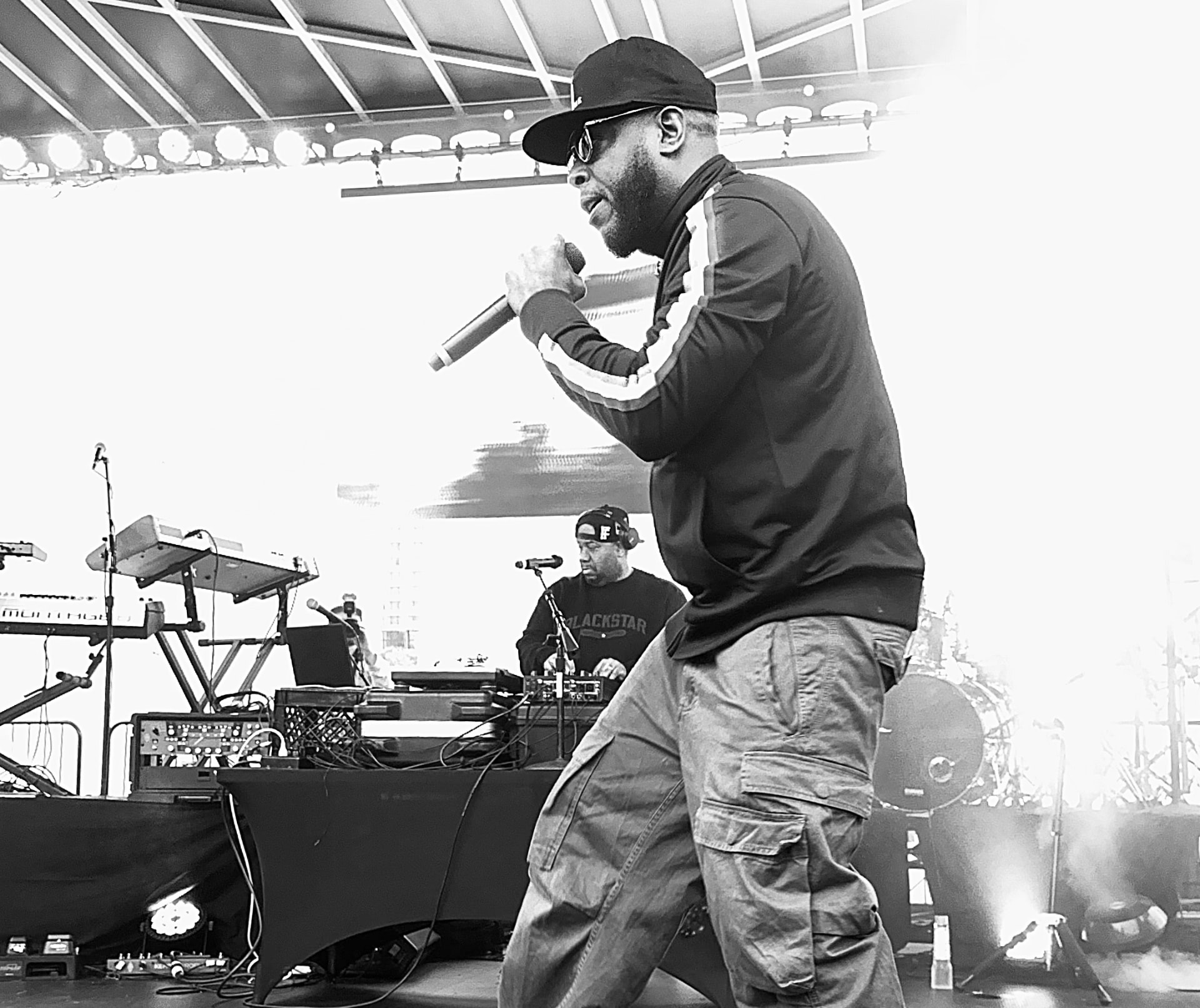 A performer holding a microphone on a concert stage